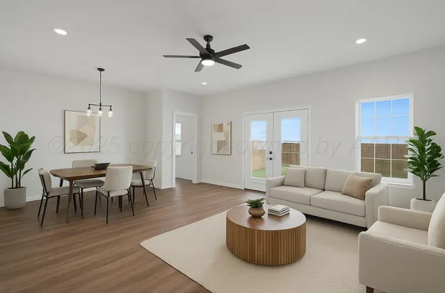 a living room with furniture and wooden floor
