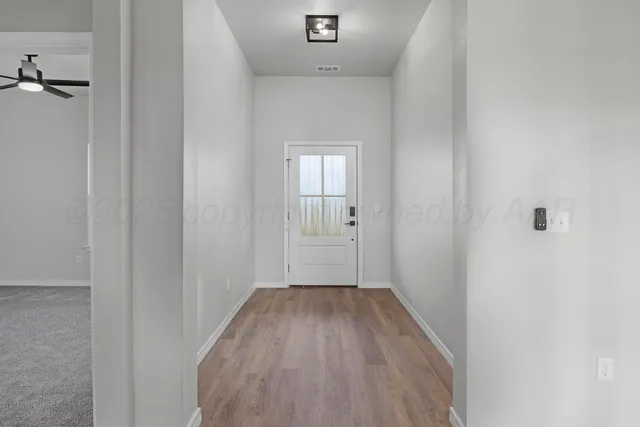 a view of a room with wooden floor