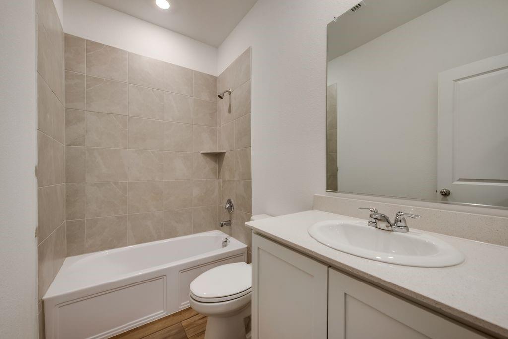204 Coconut Drive Azle, TX 76020 - Photo 16 of 20 a bathroom with a sink toilet and shower