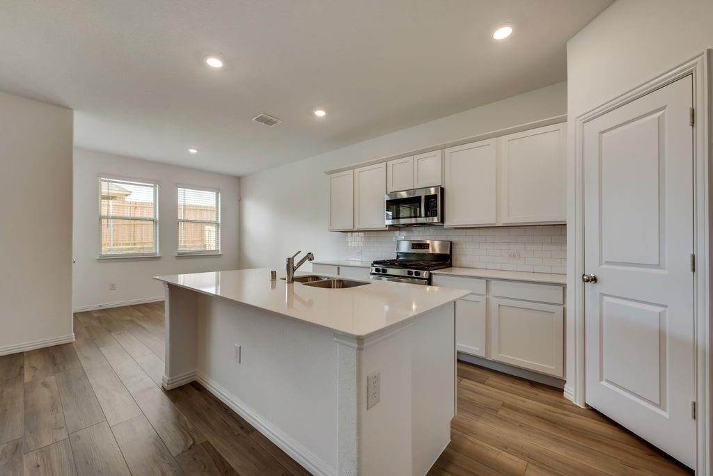 204 Coconut Drive Azle, TX 76020 - Photo 5 of 20 a kitchen with appliances a sink and cabinets