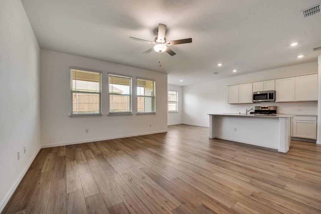204 Coconut Drive Azle, TX 76020 - Photo 20 of 20 a view of an empty room with wooden floor and a window