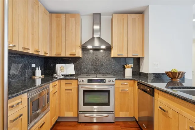 a kitchen with granite countertop a stove top oven
