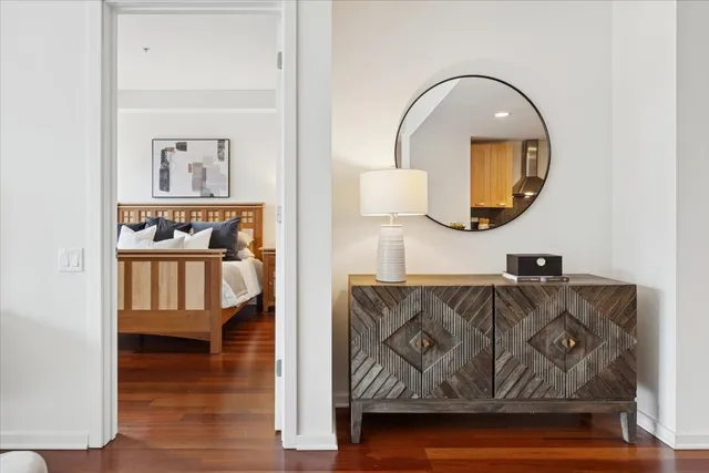 a bedroom with a bed and a night stand