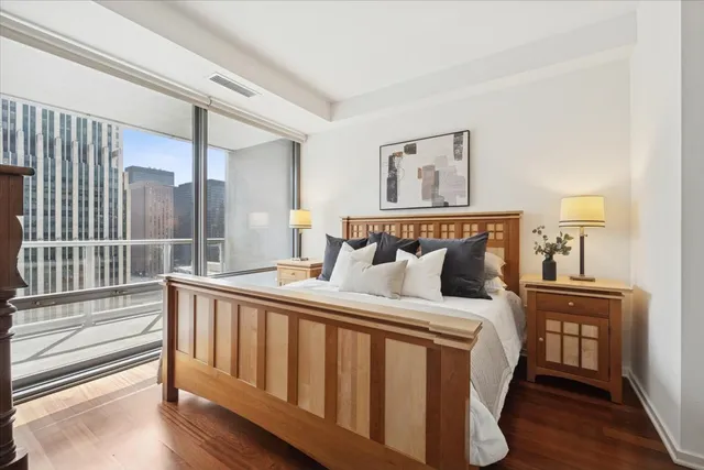 a bed sitting in a bedroom next to a window