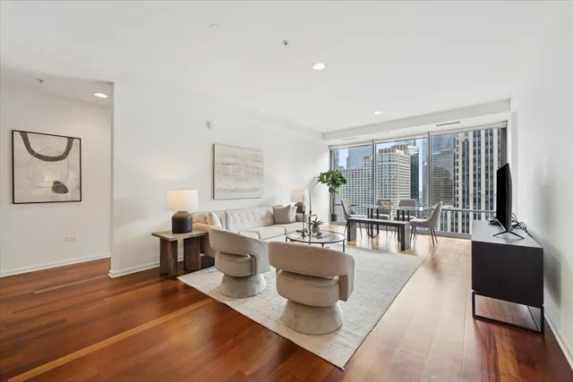 a living room with furniture and wooden floor