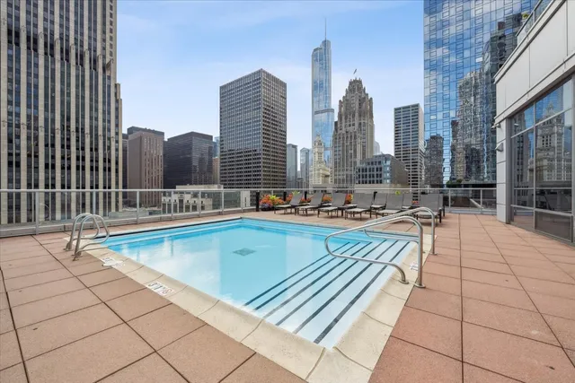 a view of a backyard with couches plants and large tree