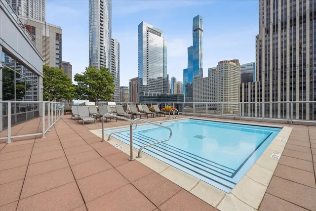 a view of a patio with a table and chairs and wooden fence