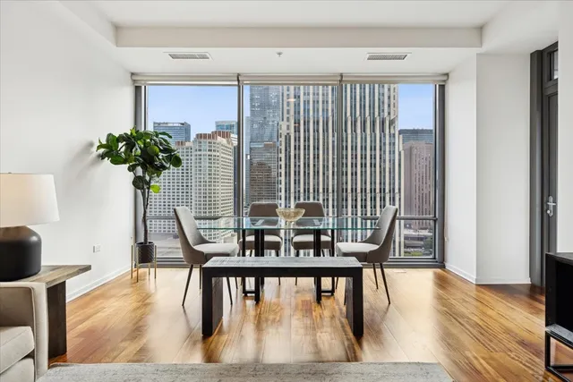 a view of a dining room with furniture and wooden floor