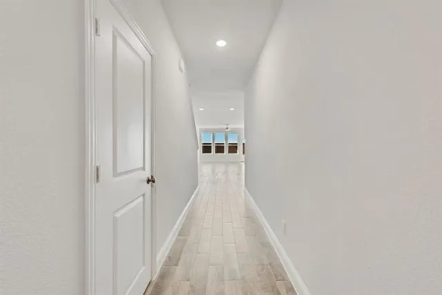 a view of a hallway with wooden floor