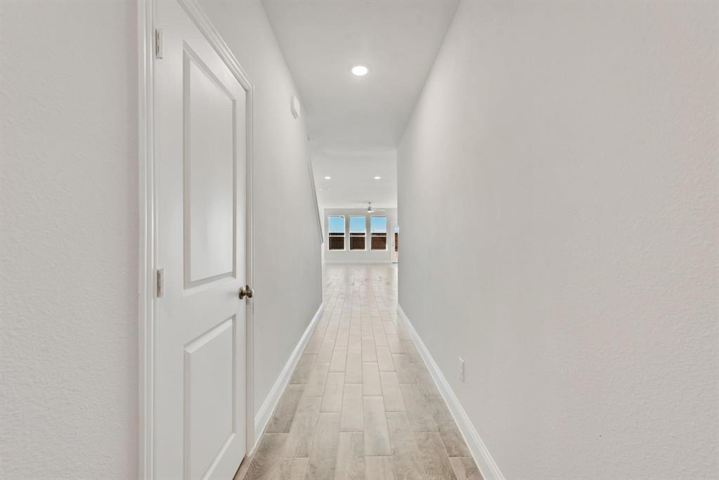3104 Camilli Cove Princeton, TX 75407 - Photo 3 of 15 a view of a hallway with wooden floor