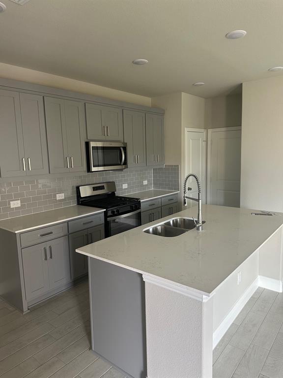 3104 Camilli Cove Princeton, TX 75407 - Photo 6 of 15 a kitchen that has a sink and a stove in it