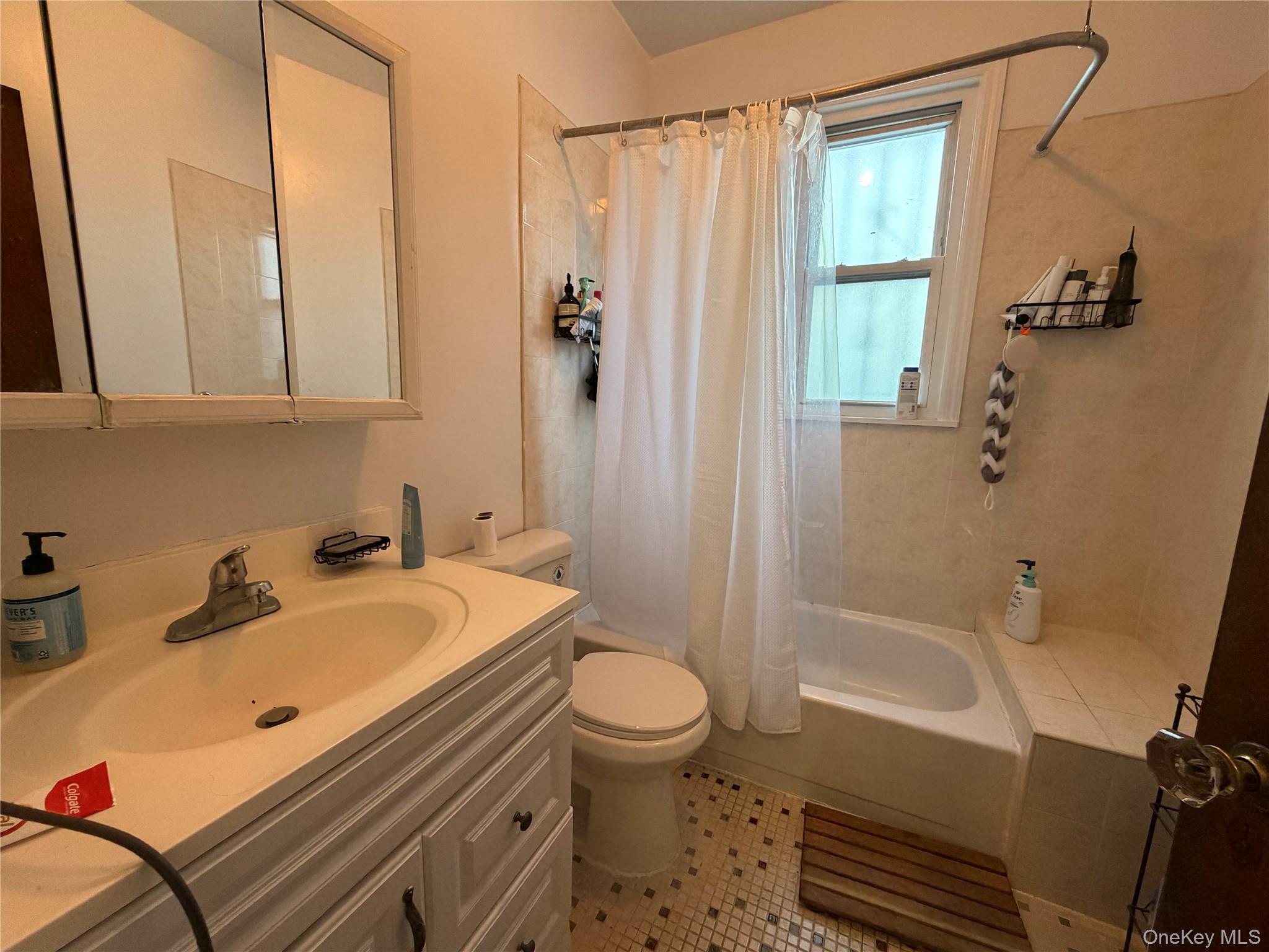 40-36 69th Street Queens, NY 11377 - Photo 13 of 32 a bathroom with a sink a toilet and shower