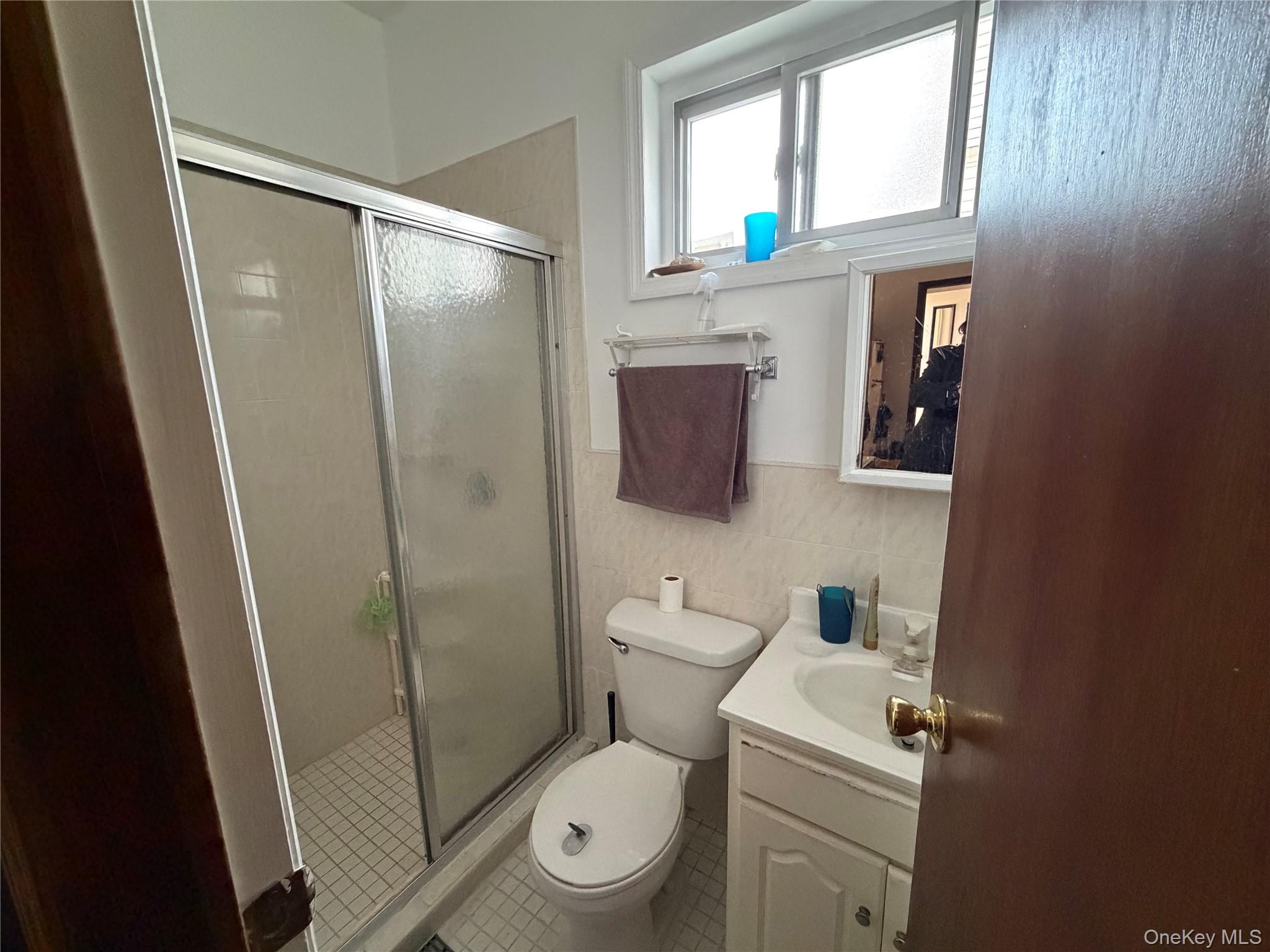 40-36 69th Street Queens, NY 11377 - Photo 18 of 32 a bathroom with a toilet and a shower