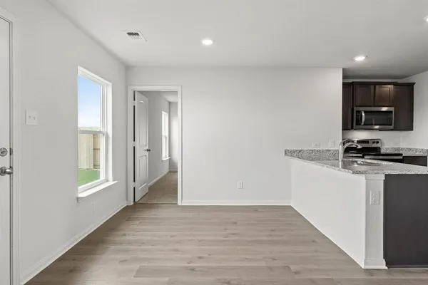 a kitchen with granite countertop a stove and a refrigerator
