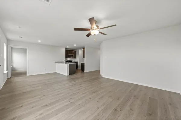 a view of a kitchen with a sink and a refrigerator