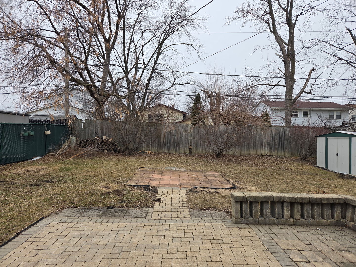 756 West Millers Road Des Plaines, IL 60016 - Photo 25 of 27 a backyard of a house with barbeque oven and wooden fence