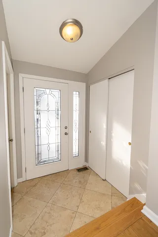 an empty room with windows and closet