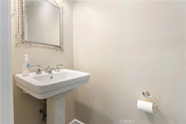 a bathroom with a sink a mirror and a toilet