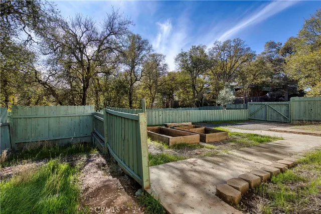 a backyard of a house with lots of green space and fountain