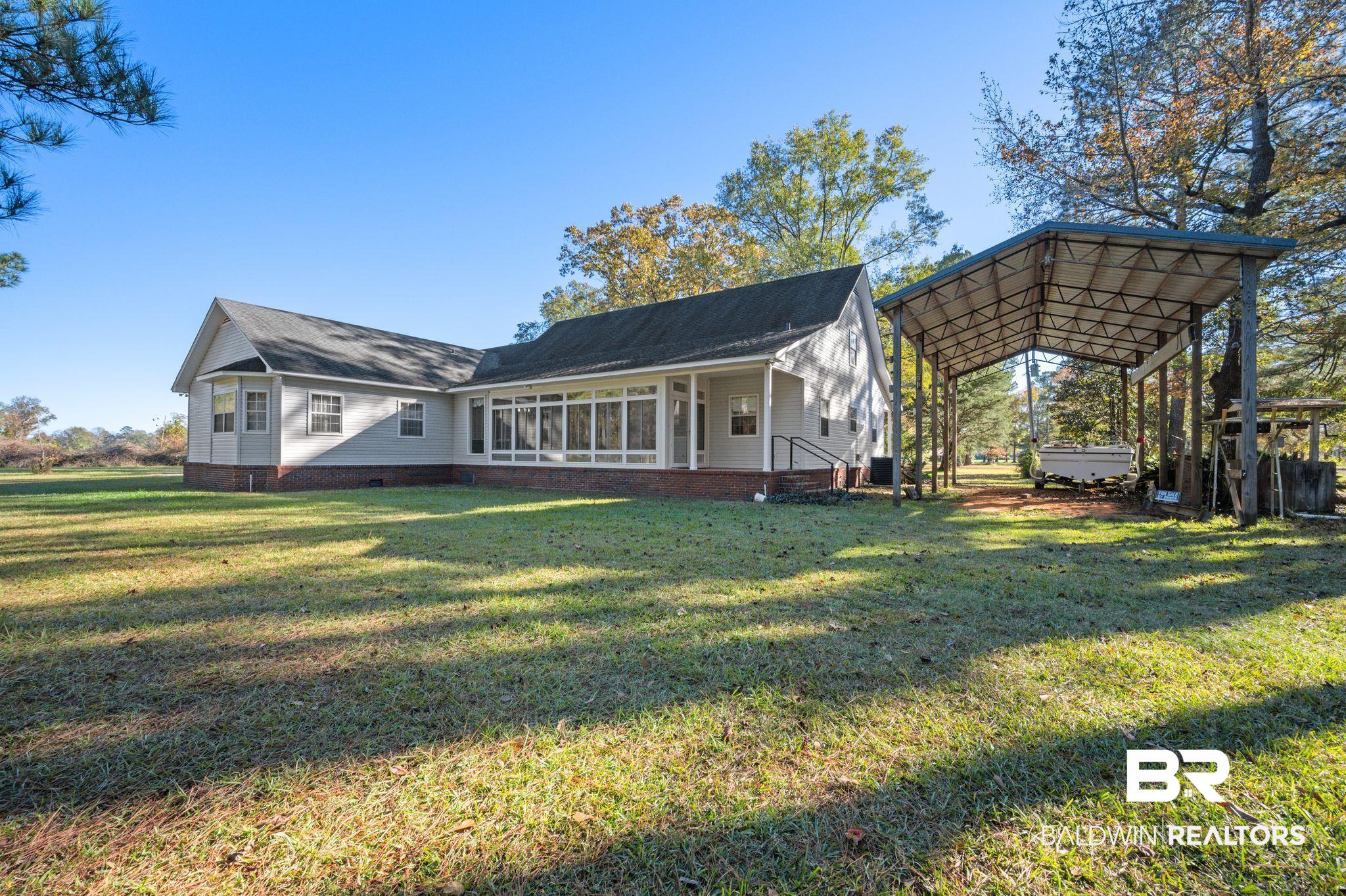 15801 Maytower Road Bay Minette, AL 36507 - Photo 33 of 43 Back of house with a yard and a carport