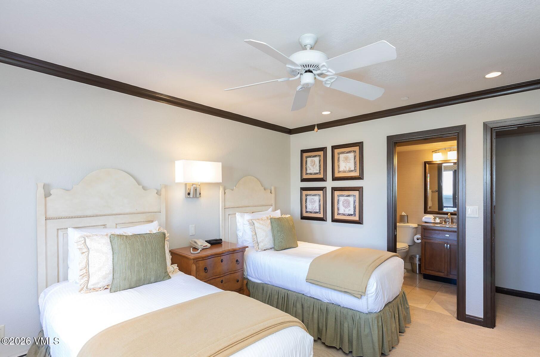 210 Offerson Road, Unit 41428 Beaver Creek, CO 81620 - Photo 12 of 25 a bedroom with two beds and a chandelier