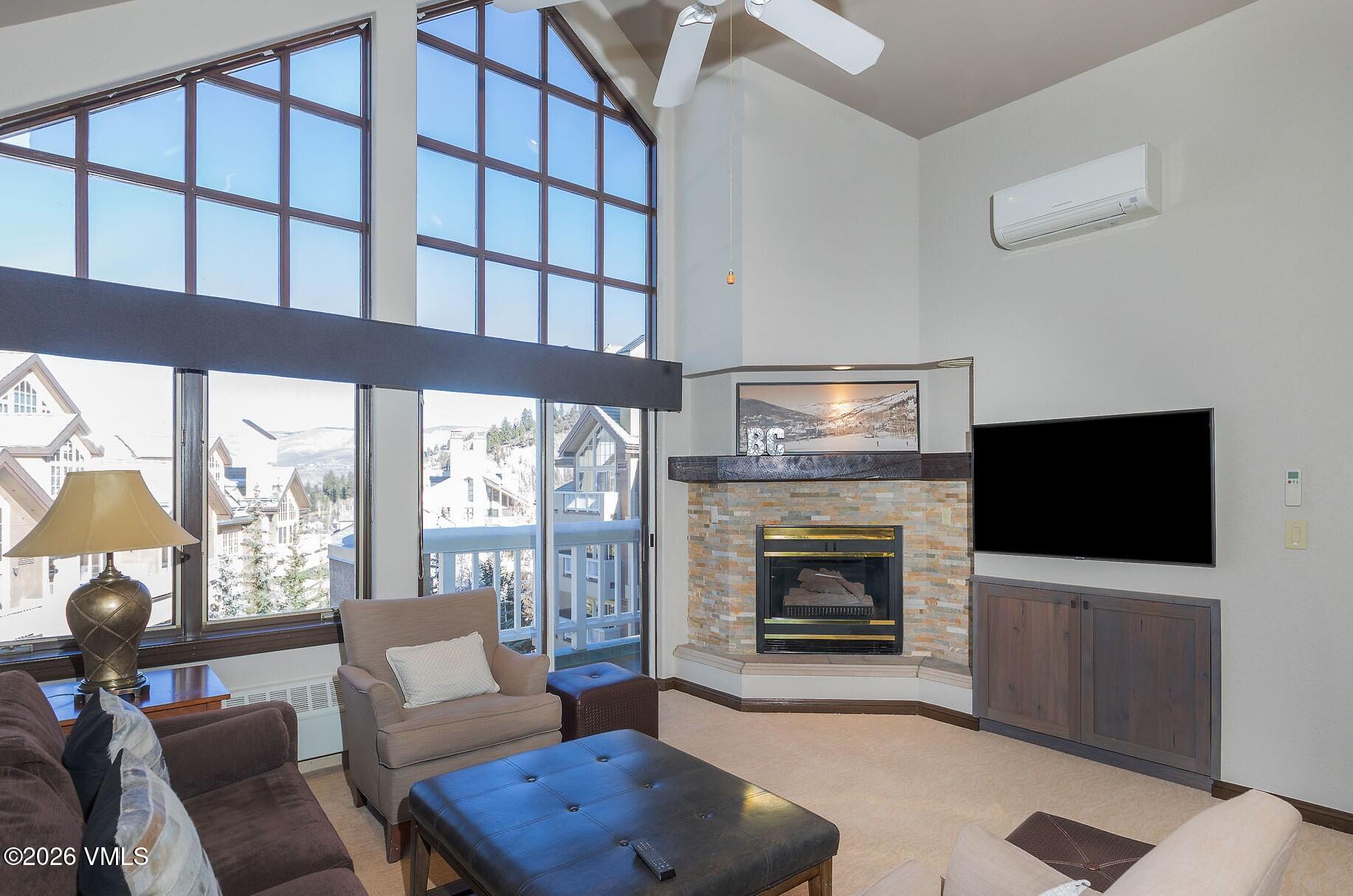 210 Offerson Road, Unit 41428 Beaver Creek, CO 81620 - Photo 2 of 25 a living room with furniture a flat screen tv and a fireplace