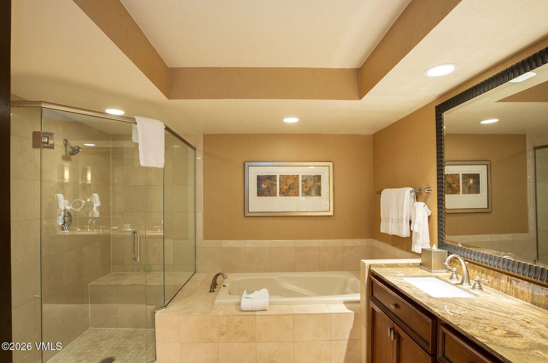 210 Offerson Road, Unit 41428 Beaver Creek, CO 81620 - Photo 9 of 25 a bathroom with a granite countertop sink a shower and a mirror