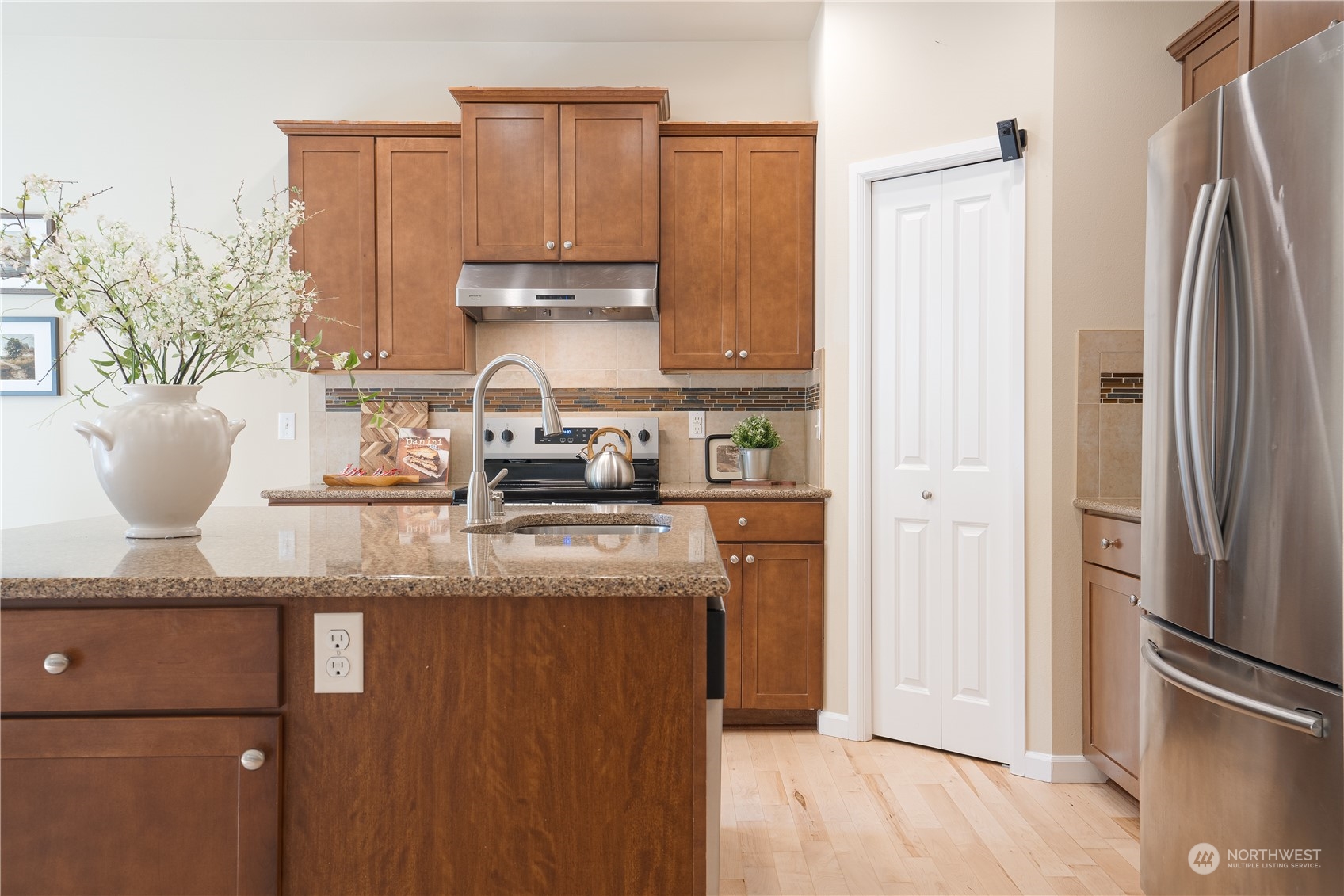 3326 177th Place Southeast Bothell, WA 98012 - Photo 11 of 26 a kitchen with stainless steel appliances granite countertop a refrigerator a stove a sink and a granite counter tops