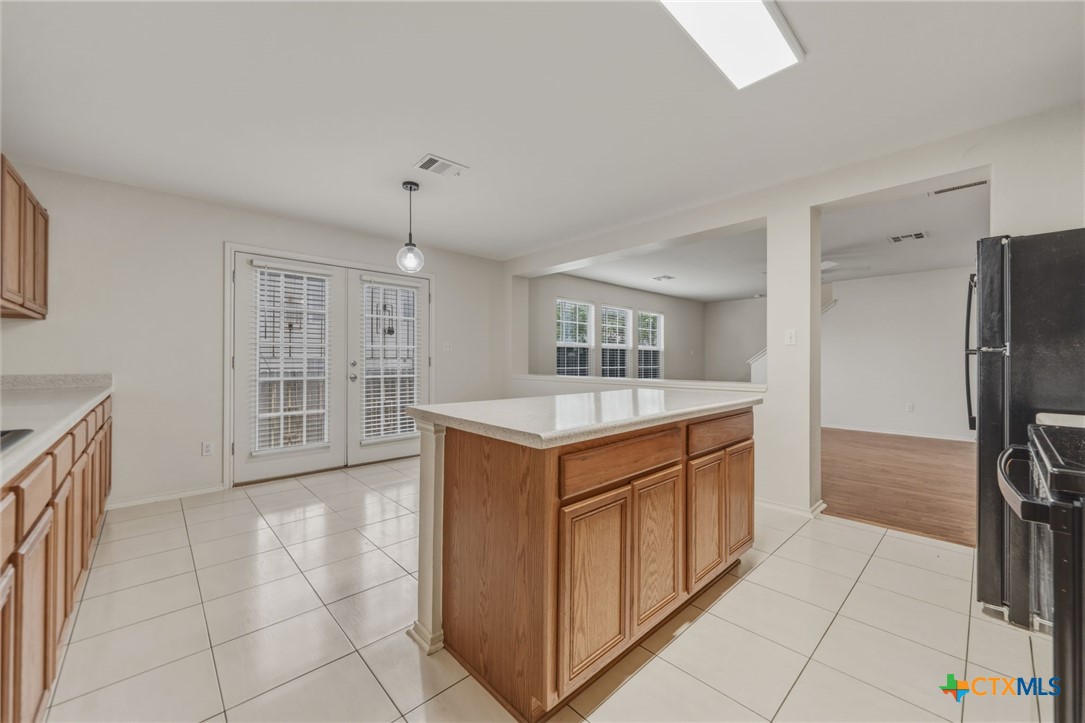 109 Comal Cove Elgin, TX 78621 - Photo 12 of 34 a kitchen with stainless steel appliances granite countertop a refrigerator and a stove