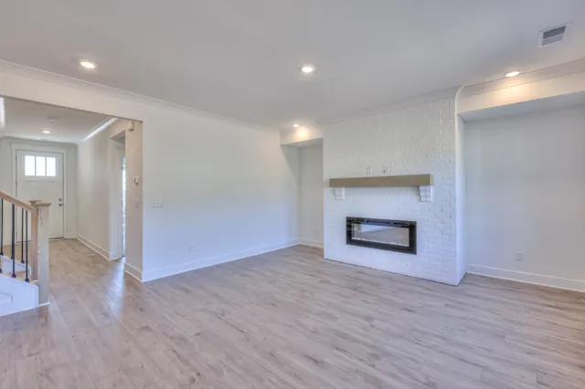 a large kitchen with stainless steel appliances kitchen island a large counter top and a wooden floors