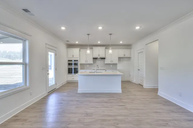 a kitchen with a sink a stove a refrigerator and a oven