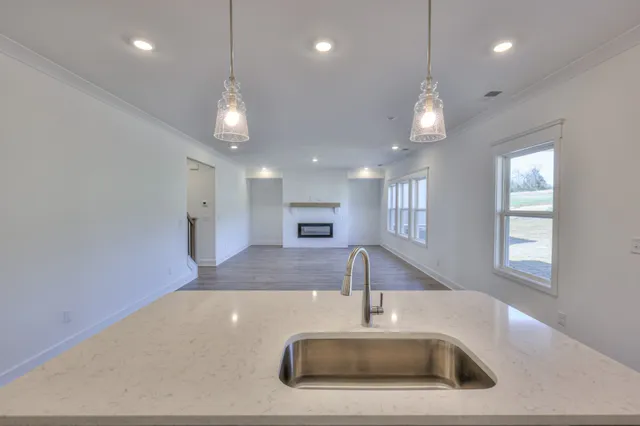 a bathroom with a glass shower door and a sink