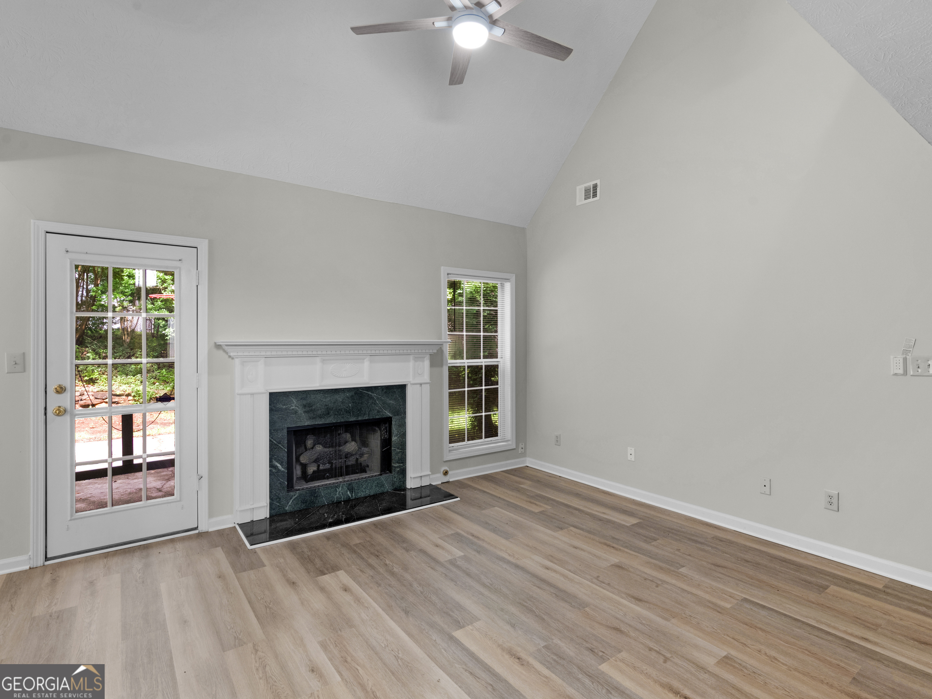 404 Northwind Place Stockbridge, GA 30281 - Photo 14 of 56 a view of an empty room with wooden floor fireplace and a window
