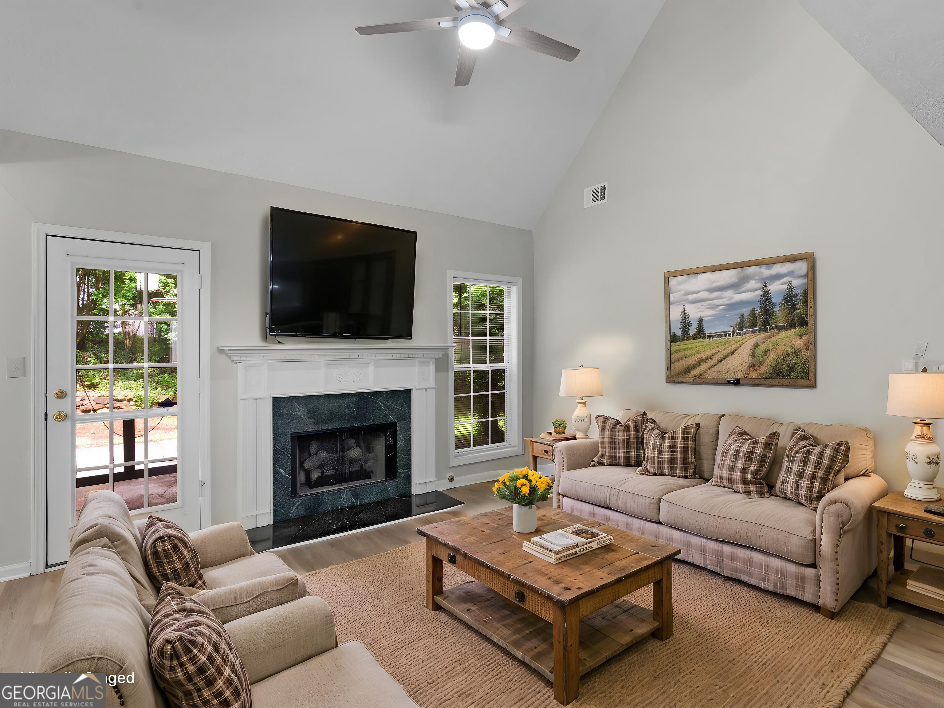 404 Northwind Place Stockbridge, GA 30281 - Photo 15 of 56 a living room with furniture a flat screen tv and a fireplace