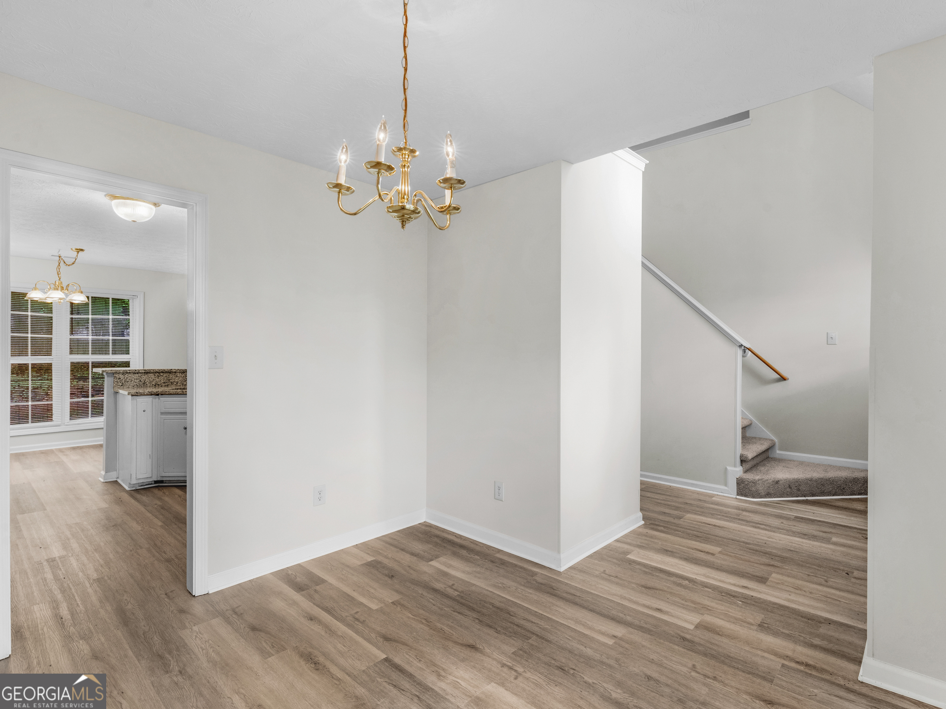 404 Northwind Place Stockbridge, GA 30281 - Photo 21 of 56 a view of an empty room with wooden floor and a ceiling fan