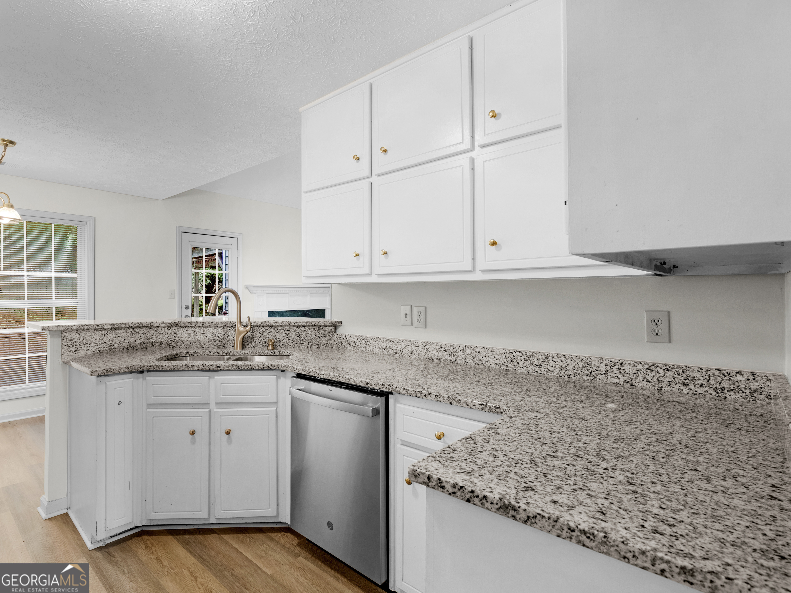 404 Northwind Place Stockbridge, GA 30281 - Photo 23 of 56 a kitchen with granite countertop white cabinets and a sink