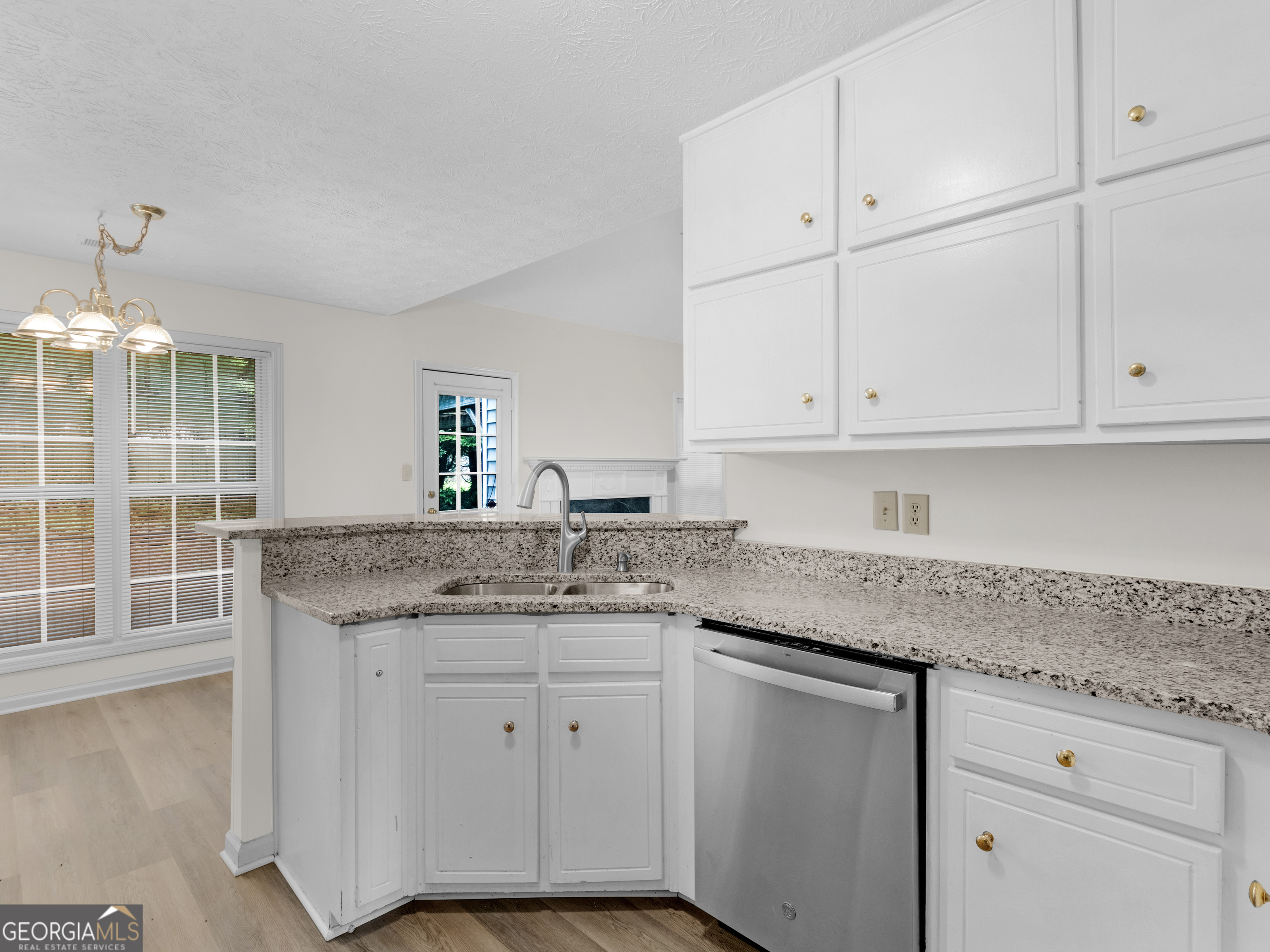 404 Northwind Place Stockbridge, GA 30281 - Photo 24 of 56 a kitchen with granite countertop stainless steel appliances white cabinets granite counter tops and a wooden floors
