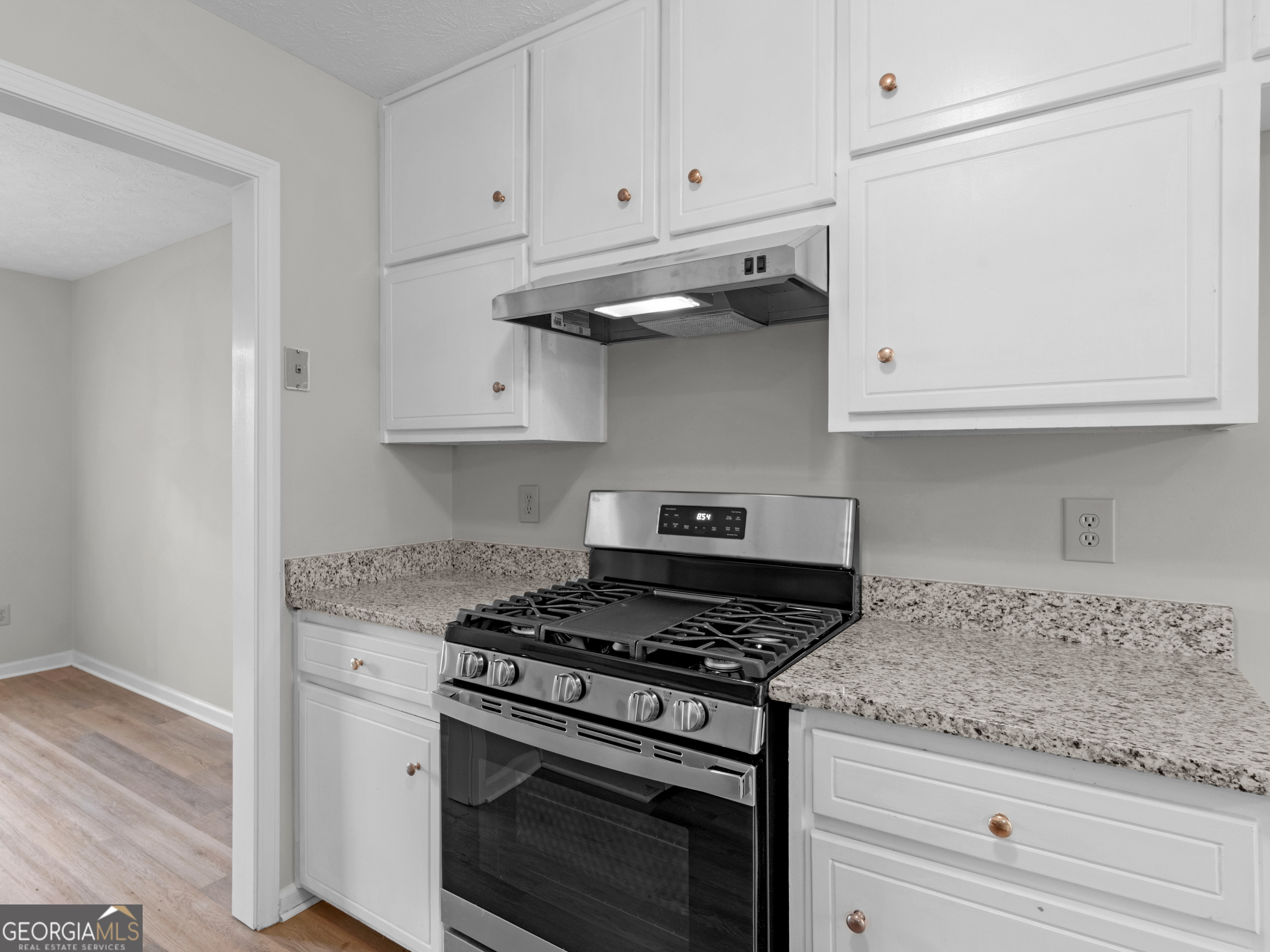 404 Northwind Place Stockbridge, GA 30281 - Photo 26 of 56 a kitchen with granite countertop white cabinets and stainless steel appliances