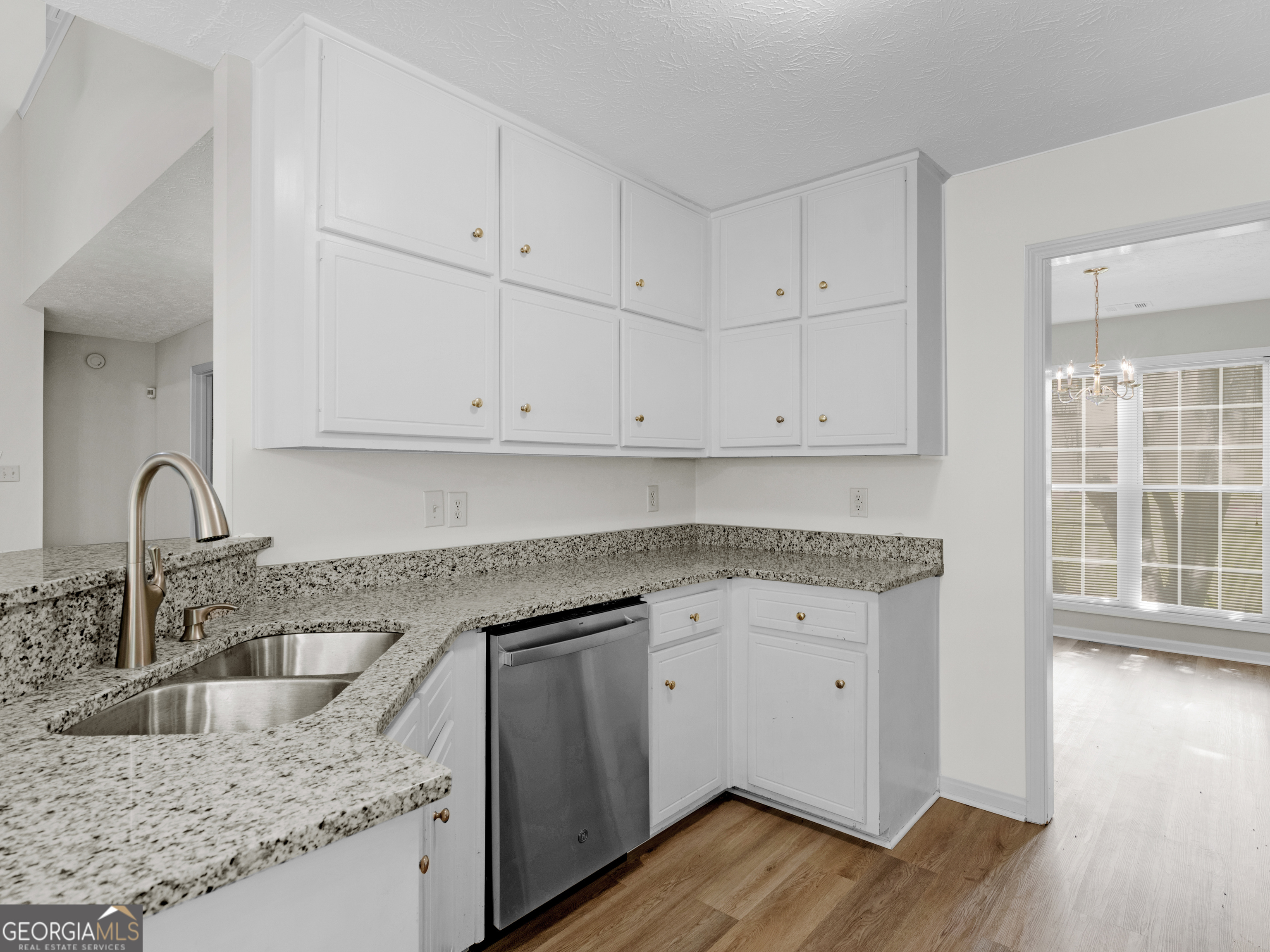 404 Northwind Place Stockbridge, GA 30281 - Photo 27 of 56 a kitchen with granite countertop white cabinets and a sink