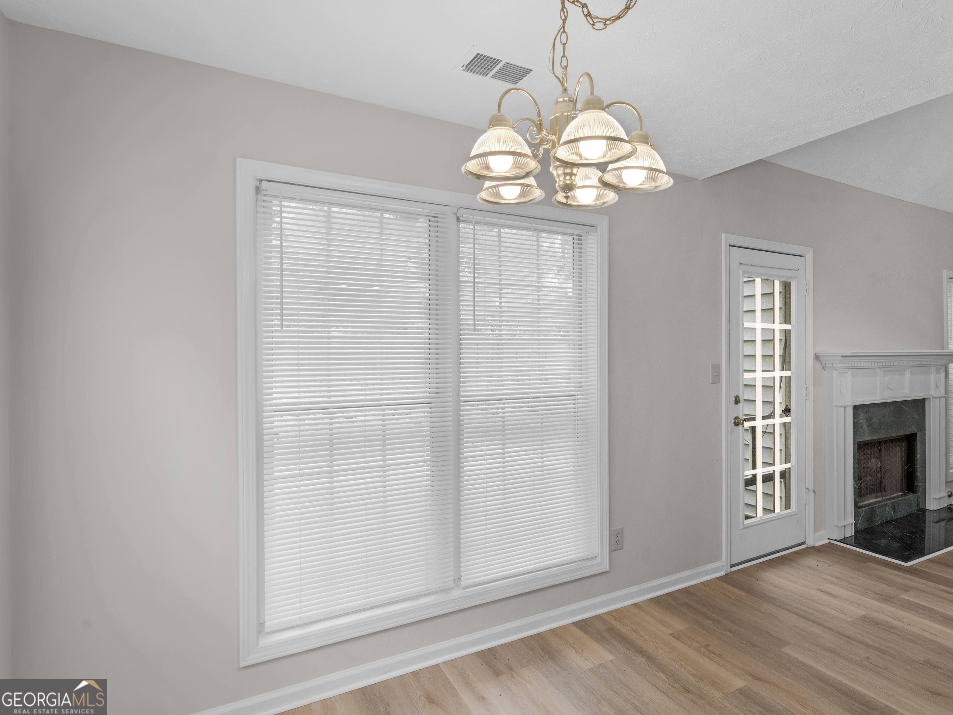404 Northwind Place Stockbridge, GA 30281 - Photo 30 of 56 an empty room with wooden floor chandelier and windows