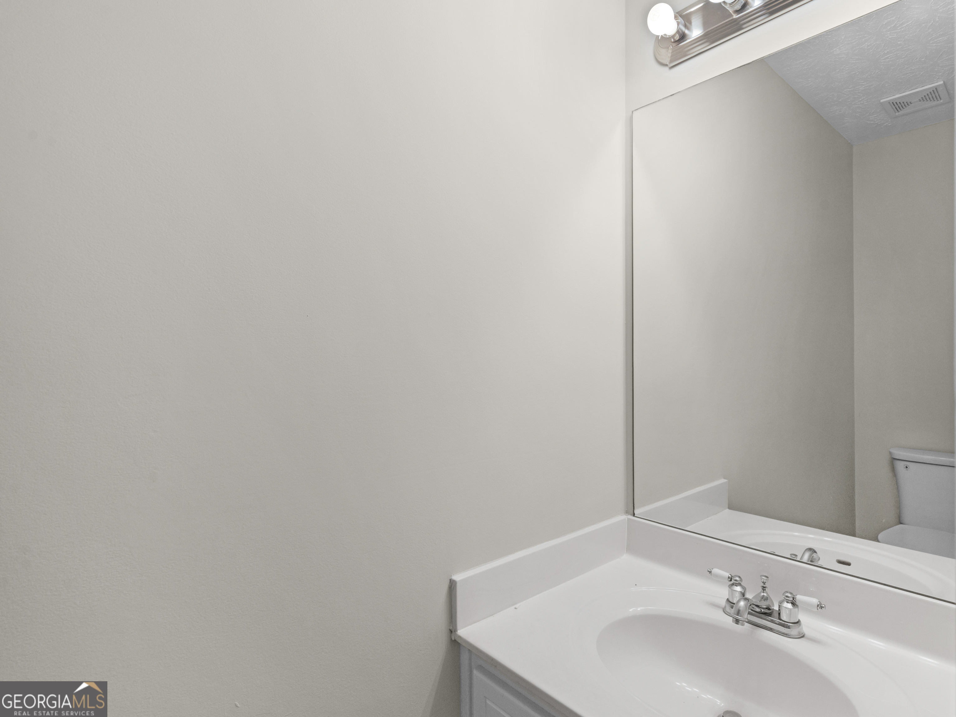 404 Northwind Place Stockbridge, GA 30281 - Photo 40 of 56 a bathroom with a sink and a mirror