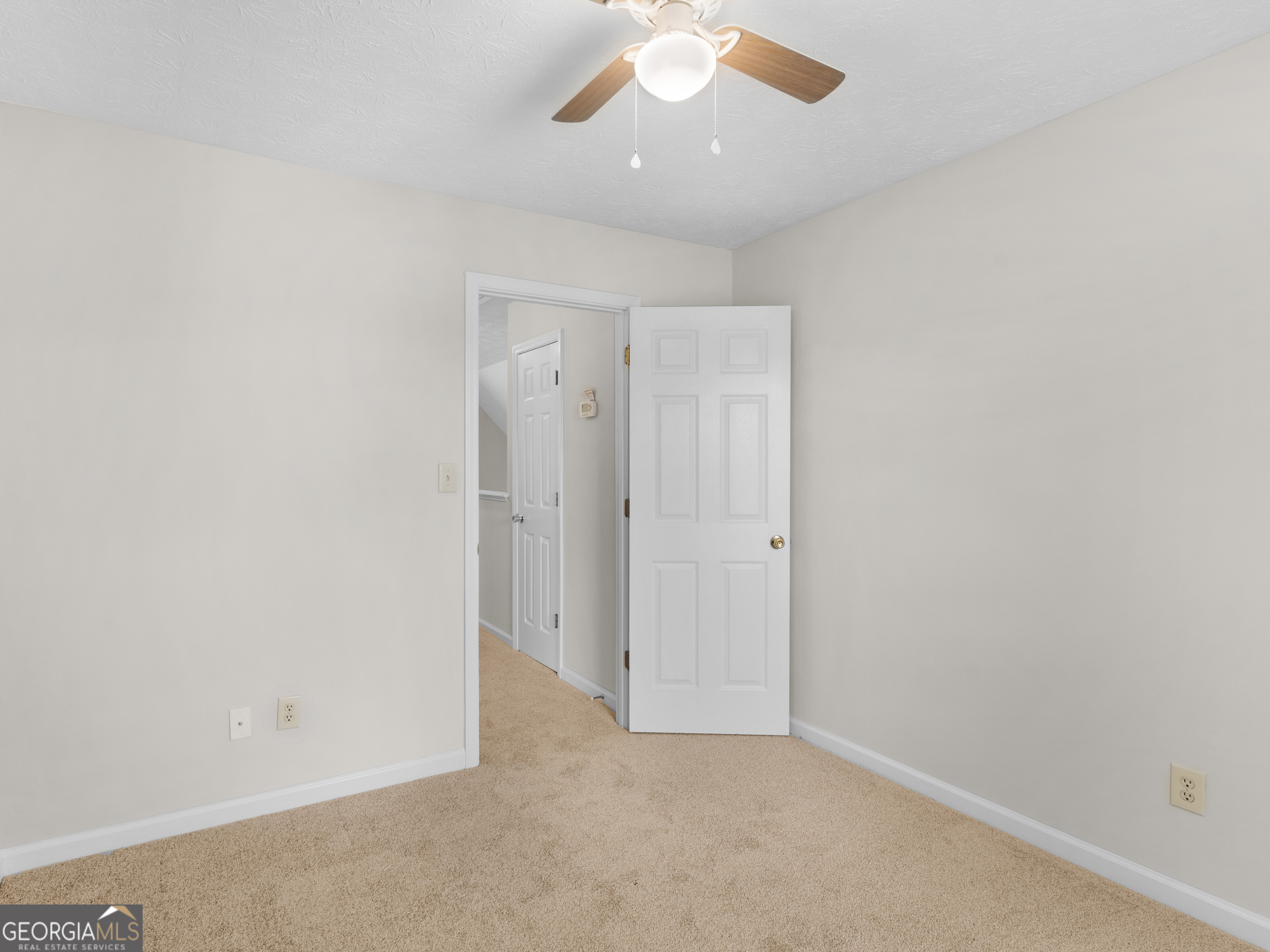 404 Northwind Place Stockbridge, GA 30281 - Photo 55 of 56 an empty room with a ceiling fan and a window