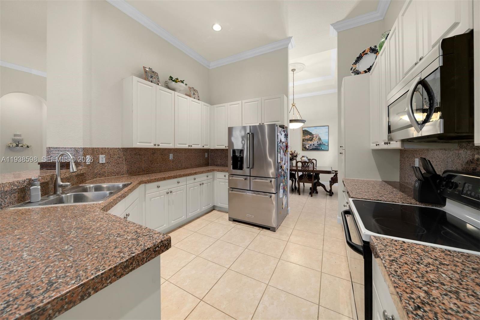 7548 Southwest 190th Street Cutler Bay, FL 33157 - Photo 11 of 53 a kitchen with stainless steel appliances granite countertop a sink a stove top oven a counter space and cabinets