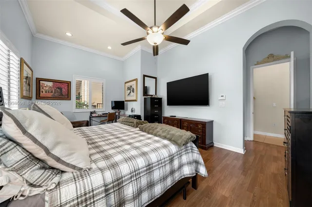 a bedroom with a bed window and a flat screen tv