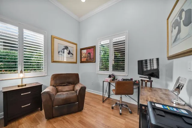 a livingroom with workspace couch and a window