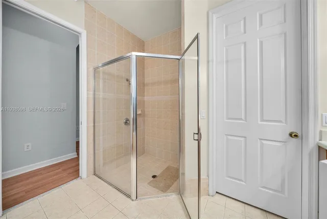 a bathroom with a glass shower door