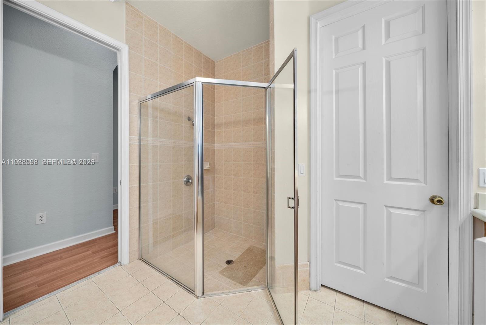 7548 Southwest 190th Street Cutler Bay, FL 33157 - Photo 23 of 53 a bathroom with a glass shower door