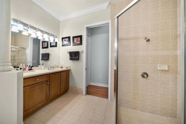 a spacious bathroom with a double vanity sink a mirror and a shower