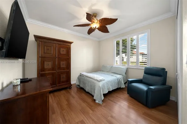 a bedroom with a bed couch and a window