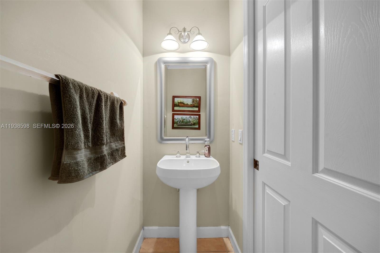 7548 Southwest 190th Street Cutler Bay, FL 33157 - Photo 30 of 53 a bathroom with a sink a mirror and shower